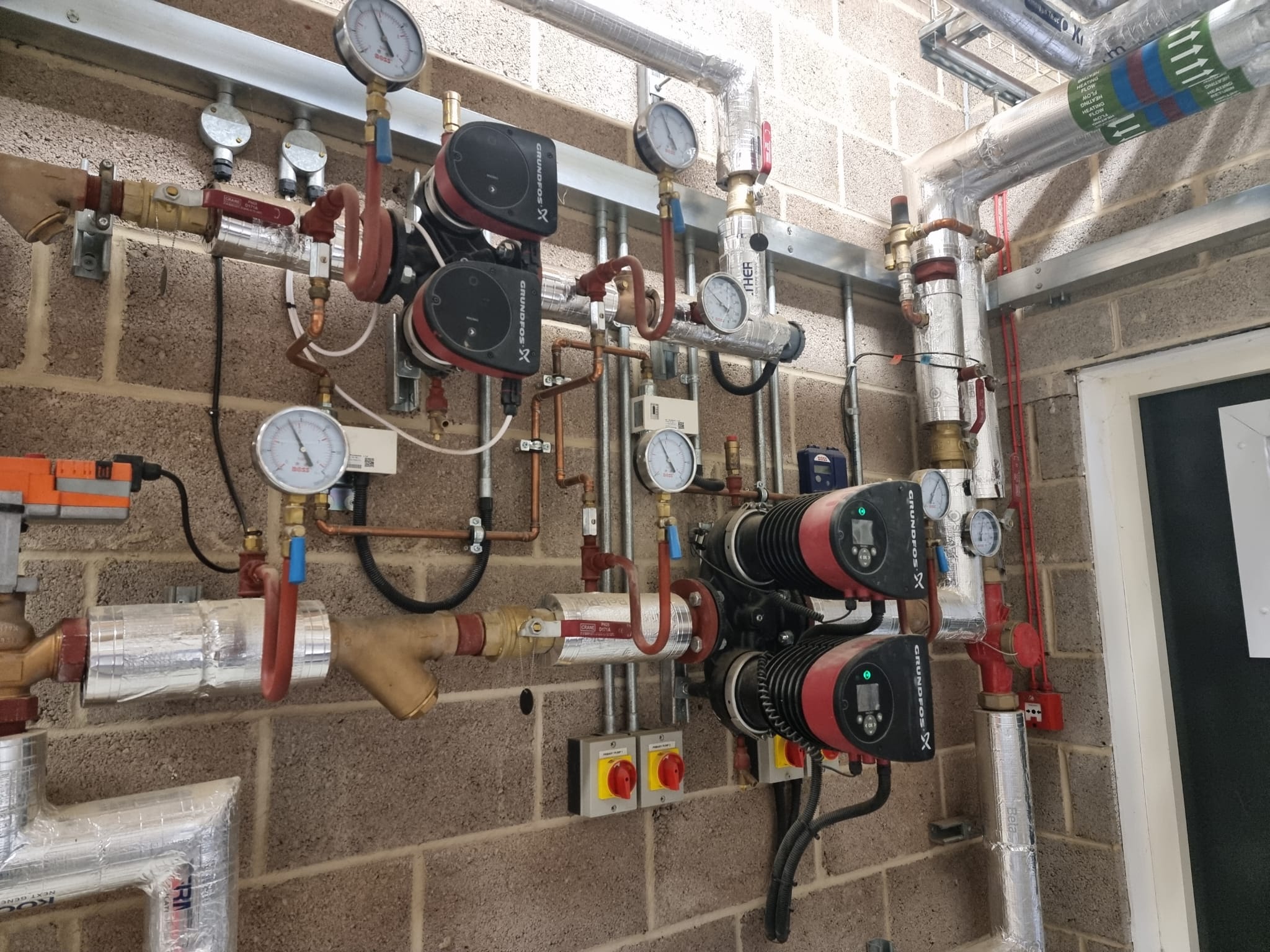 A professional plumber installing pipes and fixtures in a commercial building