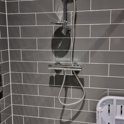Emergency plumber repairing leaking shower in Bletchley property