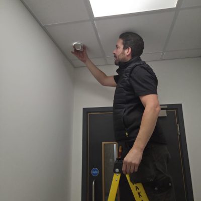 Electrician performing urgent repairs in a commercial building. Commercial emergency electrician working in Milton Keynes office