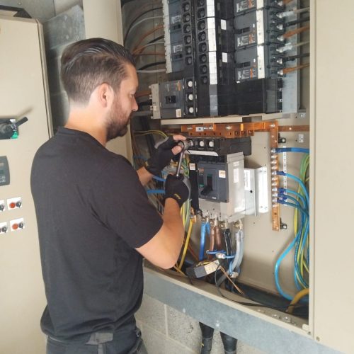 Electrician restoring electricity after a major power failure. 24/7 Emergency electrician fixing power cut in a commercial property